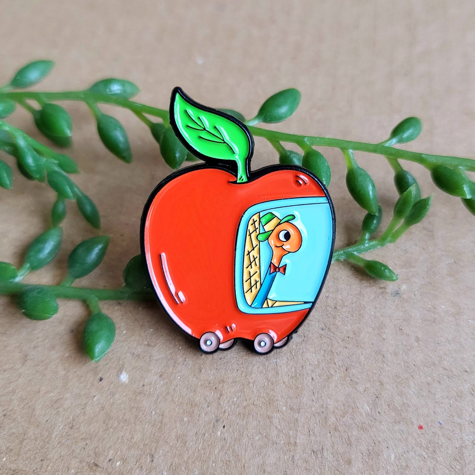 Richard Scarry enamel pin badge. Lowly worm in his red apple car enamel pin badge.